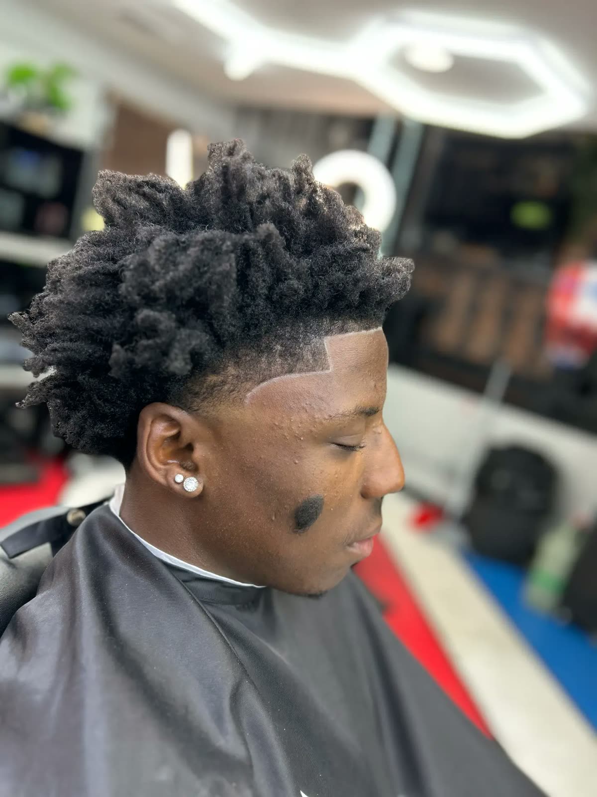 Locs with a sharp lineup and skin fade